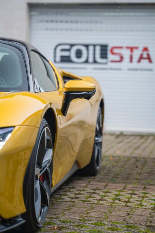 Gelber Ferrari SF90 mit Lackschutzfolie vor dem Foilsta Studio